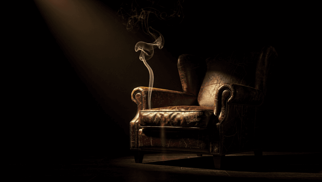 Smelling cigarette smoke from a deceased loved one: a wisp of smoke beside an empty armchair in golden light