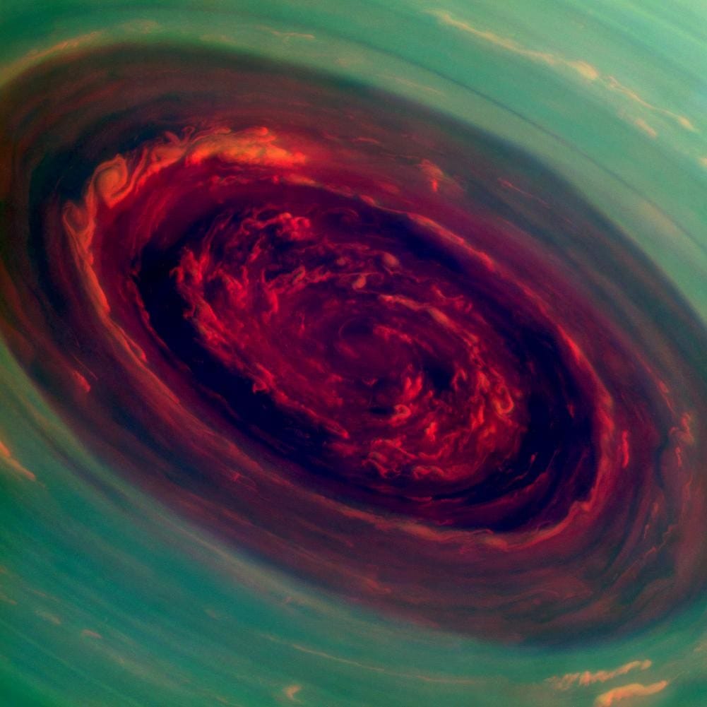 The Rose: Cassini false-color image of the giant hurricane at Saturn's north pole, its red eye about 2,000 km across